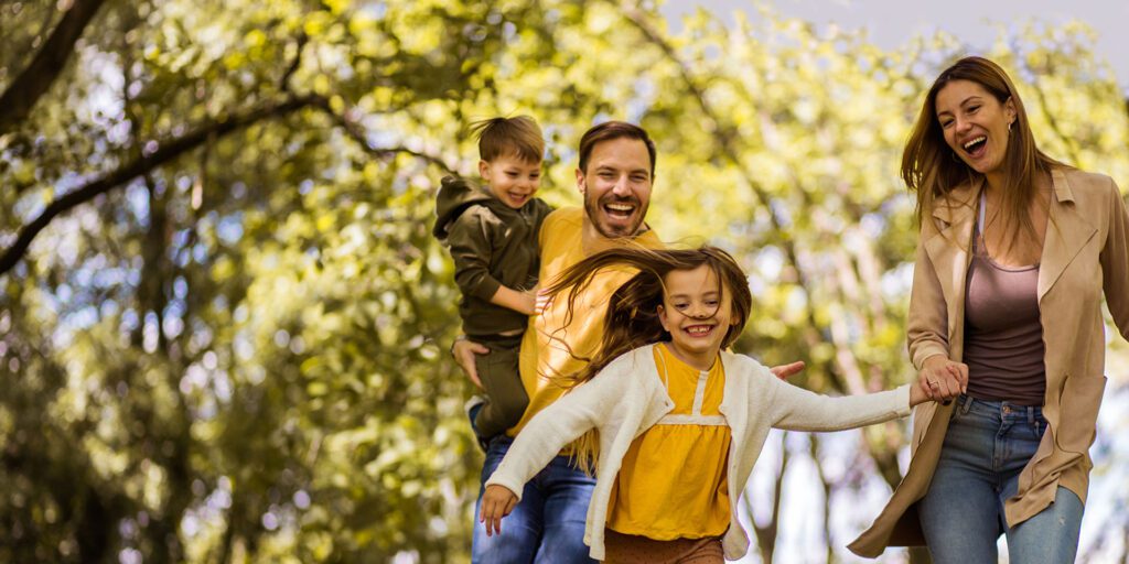 A happy family plays in the park
